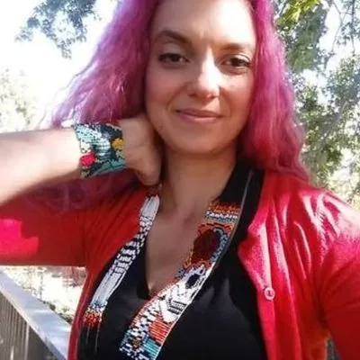 Kim in a red cardigan, a recent selfie
